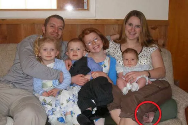 Can you guess what horrible secret is concealed in this family photo?